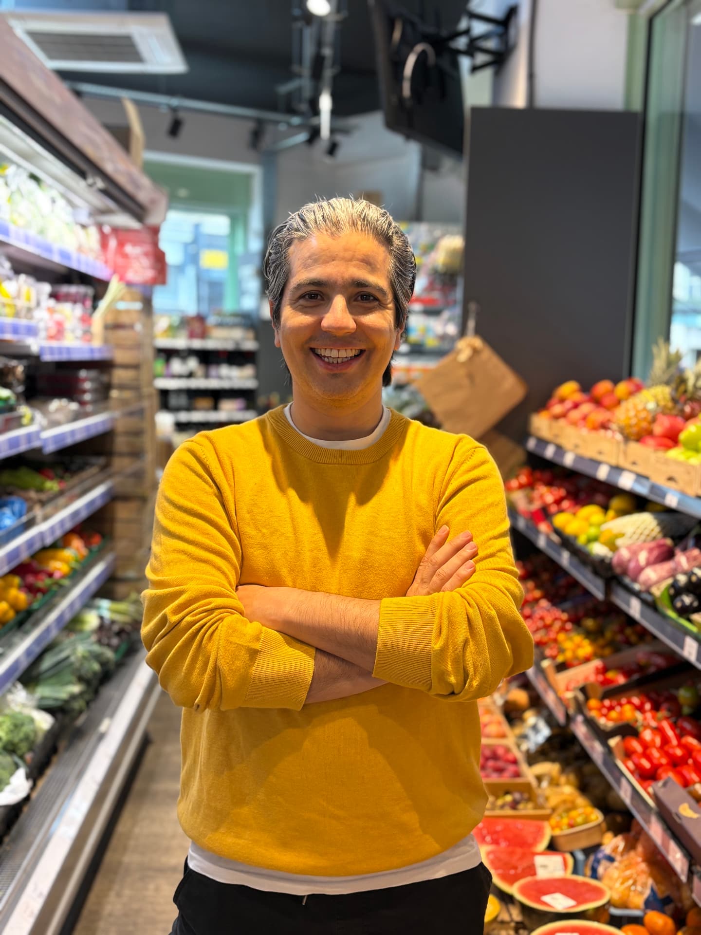 A shopkeeper handing a bag to a courier