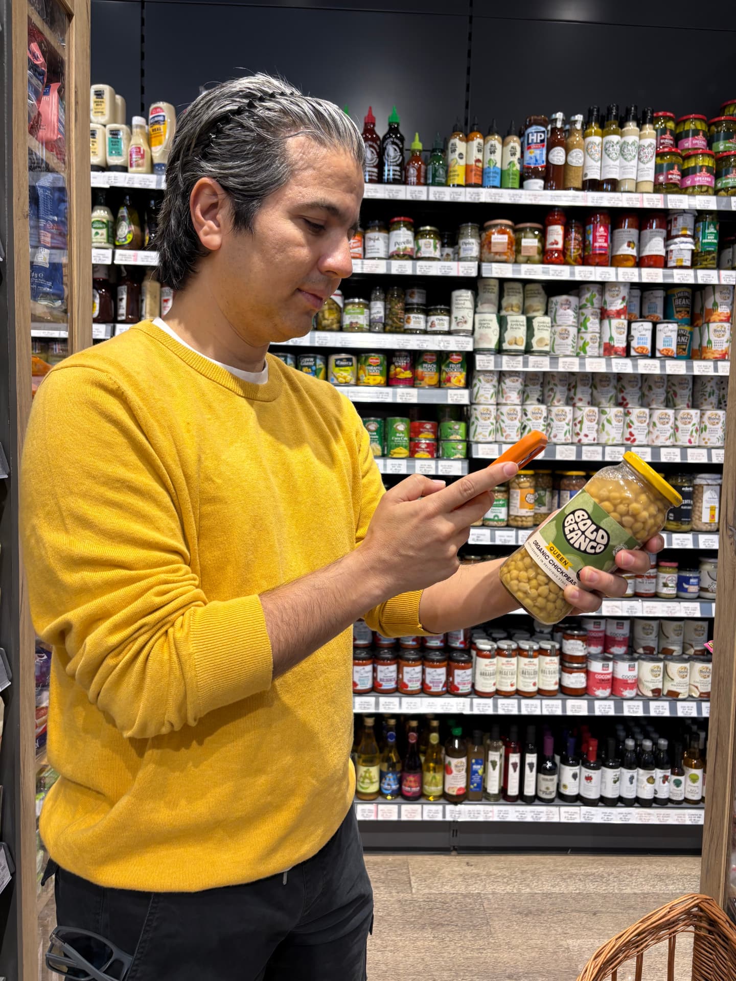 A shopkeeper scanning a product with their phone